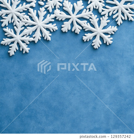 Merry Christmas, Happy New Year. Blue background white Christmas snowflakes close up 129357242