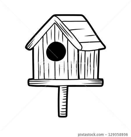 Wooden birdhouse standing on a pole, offering shelter and nesting space for birds 129358936