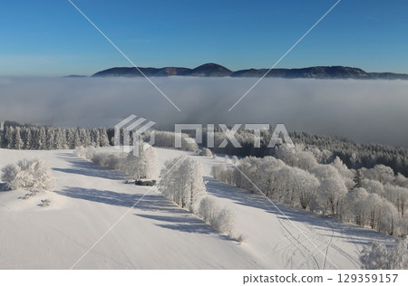 Winter landscape with inverse fog and the Crow Mountains 129359157