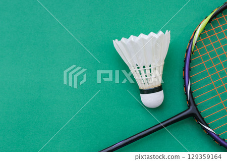 Shuttlecock and Racket on Green Background Shuttlecock and Racket on Green Background 129359164