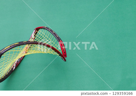Broken Badminton Racket on Green Background 129359166