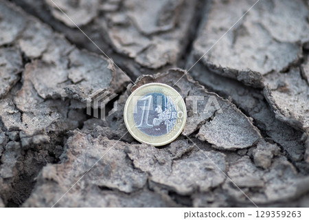 One Euro coin on cracked dry soil. Concept of economic problems in Europe, financial crisis, inflation One Euro coin on cracked dry soil. Concept of economic problems in Europe, financial crisis, inflation 129359263
