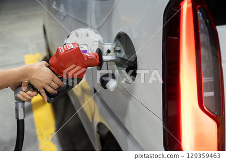 Refueling at a gas station 129359463