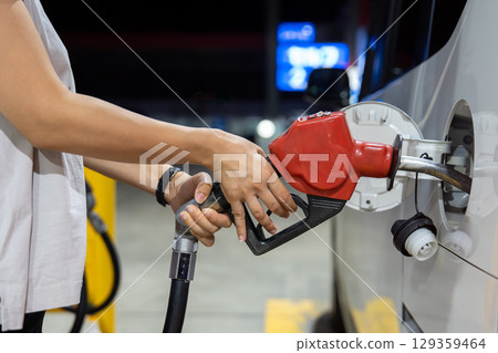 Refueling at a gas station Refueling at a gas station 129359464