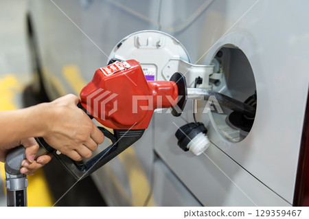 Refueling at a gas station 129359467