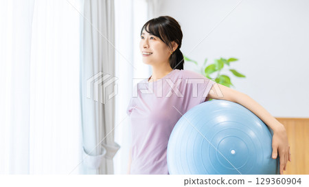 A woman with a balance ball 129360904