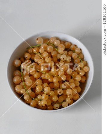 Fresh Yellow Currants in a White Bowl on White Background 129361100