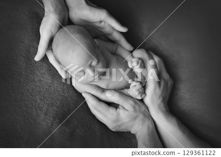 A newborn baby is wrapped in diapers with a wool cap in a basket. Swaddling, maternity hospital, family, ivf, life planning, parenting. A mother's love for her child. Baby food. High quality photo 129361122