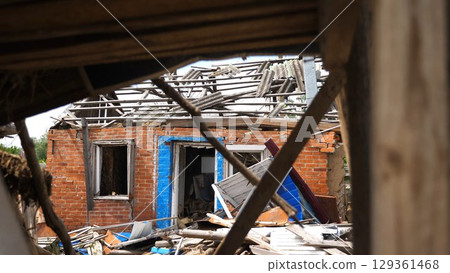 View to destroyed residential buildings at Kharkivska oblast. Ruined houses after bomb attacks on ukrainian territory from russia army. Consequences of russian invasion of Ukraine. Slow motion 129361468
