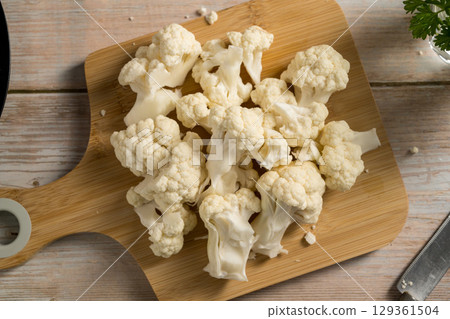 Female hands holding cauliflower lettuce pieces, cooking healthy vegetables 129361504