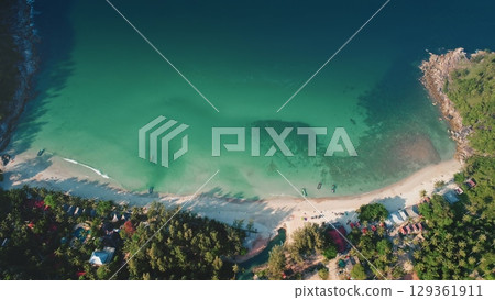 Aerial view of Bottle Beach with turquoise water, white sand, green tropical vegetation, and traditional thai boats gently rocking on the calm sea in Koh Phangan, Thailand. Travel, tourism, holiday 129361911