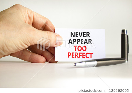 Never appear too perfect symbol. Concept words Never appear too perfect on beautiful white paper. Beautiful white background. Businessman hand. Business never appear too perfect concept. Copy space. Never appear too perfect symbol. Concept words Never appear too perfect on beautiful white paper. Beautiful white background. Businessman hand. Business never appear too perfect concept. Copy space. 129362005