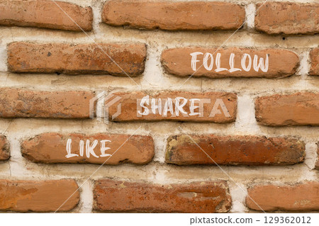 Like share follow symbol. Concept words Like Share Follow on beautiful brown brick wall. Beautiful brown brick wall background. Business like share follow concept. Copy space. 129362012