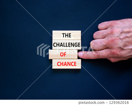The challenge of chance symbol. Concept words phrase The challenge of chance on beautiful wooden blocks. Beautiful black paper background. Business The challenge of chance concept. Copy space. The challenge of chance symbol. Concept words phrase The challenge of chance on beautiful wooden blocks. Beautiful black paper background. Business The challenge of chance concept. Copy space. 129362016