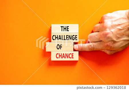The challenge of chance symbol. Concept words phrase The challenge of chance on beautiful wooden blocks. Beautiful orange paper background. Business The challenge of chance concept. Copy space. The challenge of chance symbol. Concept words phrase The challenge of chance on beautiful wooden blocks. Beautiful orange paper background. Business The challenge of chance concept. Copy space. 129362018
