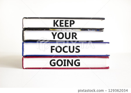 Keep your focus going symbol. Concept words Keep your focus going on beautiful books. Beautiful white table white background. Business and keep your focus going concept. Copy space. Keep your focus going symbol. Concept words Keep your focus going on beautiful books. Beautiful white table white background. Business and keep your focus going concept. Copy space. 129362034