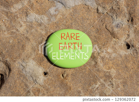 Rare earth elements symbol. Concept words Rare earth elements on beautiful green stone. Beautiful brown stone background. Business and rare earth elements concept. Copy space. 129362072