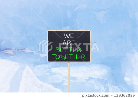 We are better together symbol. Concept words phrase We are better together on beautiful black blackboard. Beautiful blue ice background. Business We are better together concept. Copy space. We are better together symbol. Concept words phrase We are better together on beautiful black blackboard. Beautiful blue ice background. Business We are better together concept. Copy space. 129362089