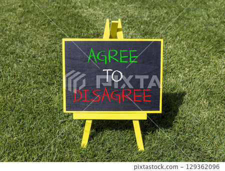Agree to disagree symbol. Concept words Agree to disagree on beautiful yellow blackboard. Beautiful green grass lawn background. Business and agree to disagree concept. Copy space. 129362096