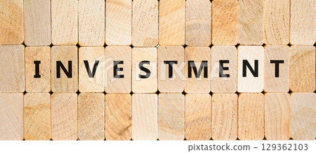 Investment symbol. Concept word Investment on beautiful wooden blocks. Beautiful wooden blocks background. Business investment concept. Copy space. Investment symbol. Concept word Investment on beautiful wooden blocks. Beautiful wooden blocks background. Business investment concept. Copy space. 129362103