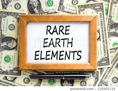 Rare earth elements symbol. Concept words Rare earth elements on beautiful wooden picture frame. Black pen. Beautiful background from dollar bills. Business and rare earth elements concept. Copy space Rare earth elements symbol. Concept words Rare earth elements on beautiful wooden picture frame. Black pen. Beautiful background from dollar bills. Business and rare earth elements concept. Copy space 129362114