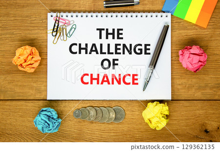 The challenge of chance symbol. Concept words phrase The challenge of chance on beautiful white note. Colored paper. Beautiful wooden background. Business The challenge of chance concept. Copy space. The challenge of chance symbol. Concept words phrase The challenge of chance on beautiful white note. Colored paper. Beautiful wooden background. Business The challenge of chance concept. Copy space. 129362135