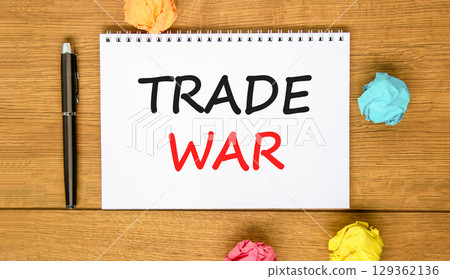 Trade war symbol. Concept word Trade war on beautiful white note. Black pen, colored paper. Beautiful wooden background. Business trade war concept. Copy space. 129362136
