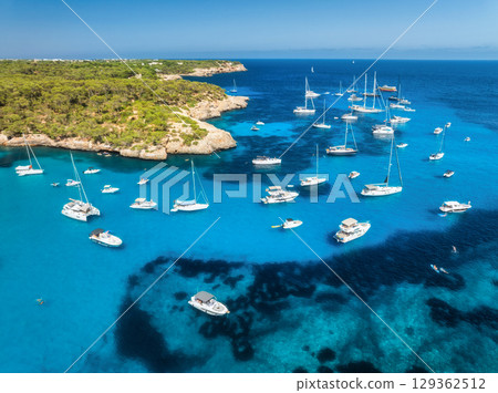 Aerial view of luxury yachts and boats anchored in turquoise sea 129362512