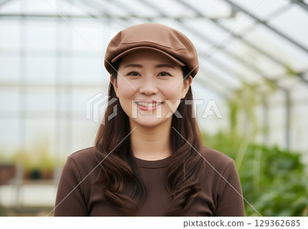 A woman working in a greenhouse 129362685