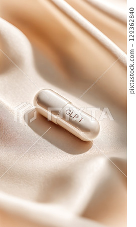 White Capsule Marked GLP1 On Soft Beige Silk Fabric For Luxury Wellness Visuals, Modern Healthcare Concepts, Weight Management Trends, And Premium Pharmaceutical Branding Content White Capsule Marked GLP1 On Soft Beige Silk Fabric For Luxury Wellness Visuals, Modern Healthcare Concepts, Weight Management Trends, And Premium Pharmaceutical Branding Content 129362840