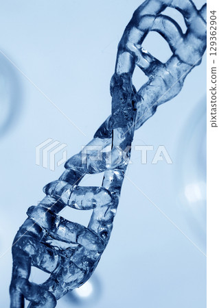 DNA Helix. Close-up of a transparent blue DNA helix with a scientific and futuristic atmosphere. 129362904