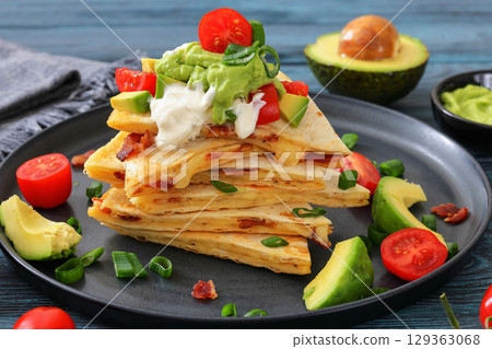 quesadilla with cheese, bacon, avocado on a plate 129363068
