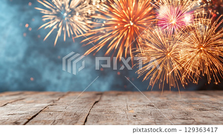 Vibrant fireworks display over rustic wooden table at night 129363417