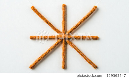 Starburst pattern of granulated pretzel sticks displayed creatively 129363547