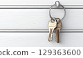 Two brass keys hanging on white wooden wall evoke curiosity 129363600