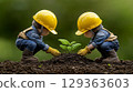 Two child figurines planting sprout in rich soil 129363603