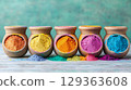 Vibrant colored powders in earthenware pots create joyful display 129363608