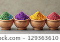 Vibrant colored powders in wooden bowls create stunning display 129363610