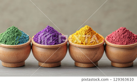 Vibrant colored powders in wooden bowls create stunning display 129363610