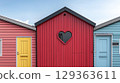 Vibrant colorful beach houses with heart shaped window create 129363611