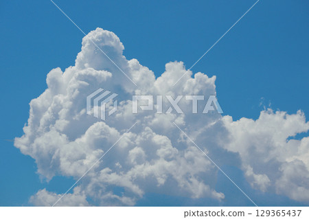 Cumulonimbus Cloud Formation Against Clear Blue Sky 129365437