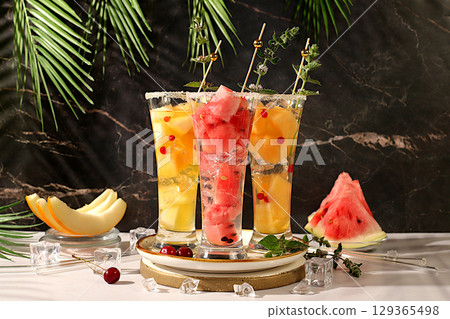 Lemonade with watermelon, melon, currant, mint, Refreshing summer homemade cocktail, sangria, weight loss concept, healthy and natural nutrition, detox water with fruit flavor on a light background 129365498