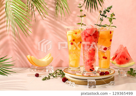Lemonade with watermelon, melon, currant, mint, Refreshing summer homemade cocktail, sangria, weight loss concept, healthy and natural nutrition, detox water with fruit flavor on a light background 129365499