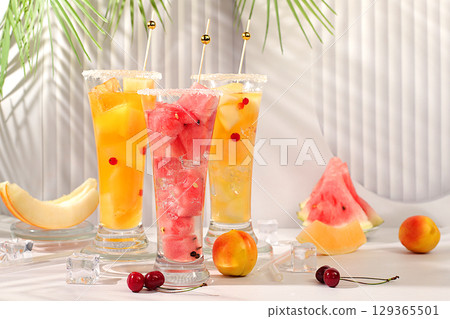 Refreshing summer homemade cocktail, sangria, lemonade with watermelon, melon, currant, mint, weight loss concept, healthy and natural nutrition, detox water with fruit flavor on light background 129365501