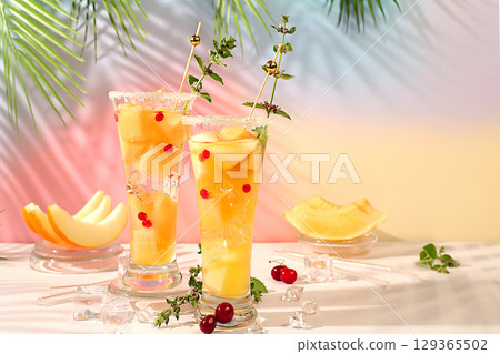 Refreshing summer homemade cocktail, sangria, lemonade with melon, currant, mint, weight loss concept, healthy and natural nutrition, detox water with fruit flavor on light background 129365502
