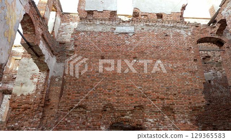 Deteriorating brick walls of an old building Deteriorating brick walls of an old building 129365583