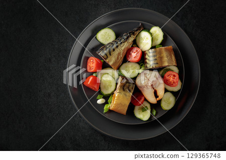 Smoked mackerel with fresh cucumbers, tomatoes and green onion. Smoked mackerel with fresh cucumbers, tomatoes and green onion. 129365748