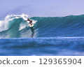 Male surfer on a blue wave 129365904
