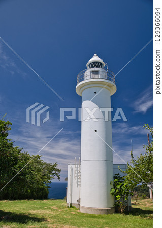 Pure white lighthouse 5 that stands out against the blue sky 129366094