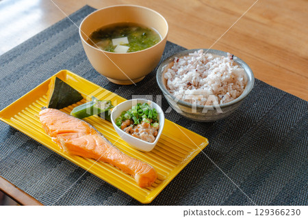 一份健康的日式早餐,包括烤鮭魚、納豆和雜糧米飯 一份健康的日式早餐,包括烤鮭魚、納豆和雜糧米飯 129366230